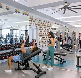 Image Of College Students Exercising in Fitness Center