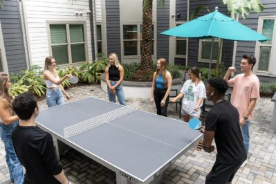 A group of residents playing ping pong in the courtyard